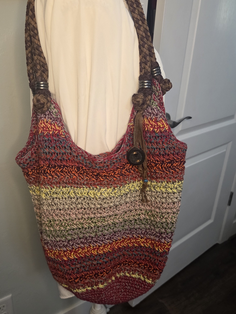 The Sak Handwoven Multicolor Crochet Tote with Brown Leather Tassels.